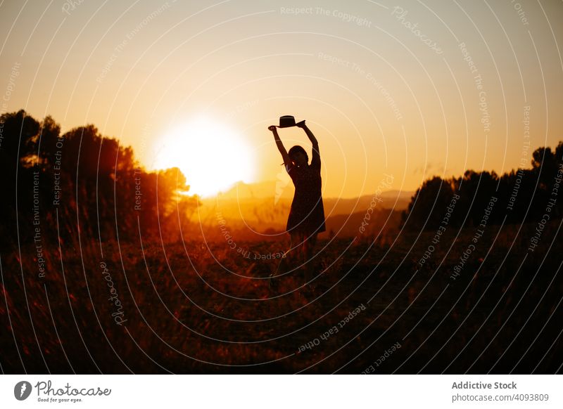Anonymous woman dancing during sundown dance sunset field nature evening sky silhouette bright freedom female lifestyle rest relax joy dusk twilight meadow