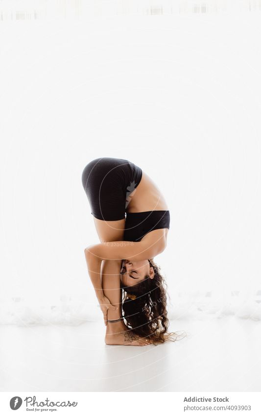 Sportive woman performing yoga pose in room practicing position relaxation exercise beautiful fitness sport leisure female workout meditate wellness sportswear