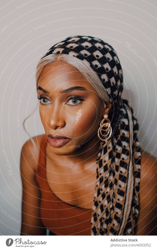 Attractive black woman wearing headscarf and brown dress beautiful style culture traditional vogue individuality model female adult glamour gloss accessory
