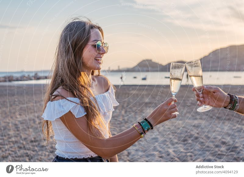 Happy family drinking wine on beach celebration clink wineglass laugh evening sea resort together father mature daughter young sibling parent beverage alcohol