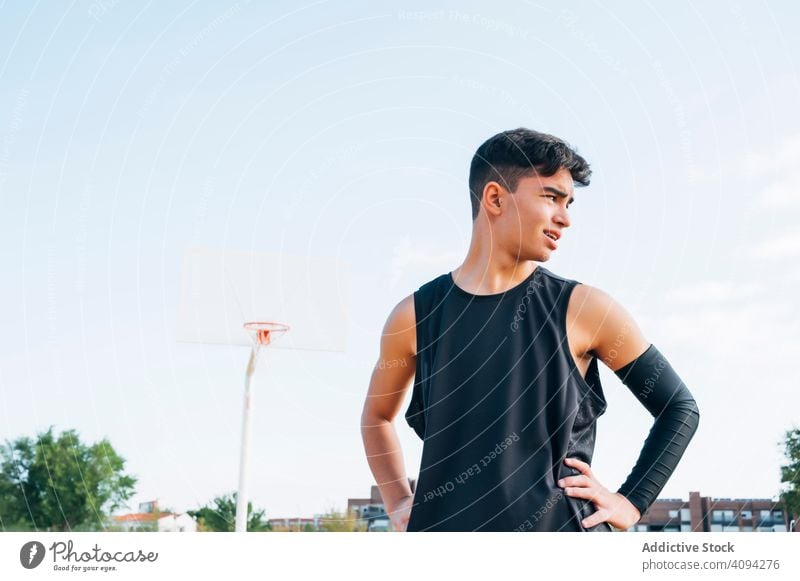 Young man playing on basketball court outdoor. athlete competition sports equipment adult recreation action portrait active activity asphalt athletic city drop