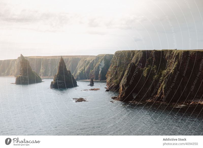 Picturesque seascape with whimsical cliffs rock landscape water duncansby head travel destination trip tourism cone shaped formation stone scenery picturesque