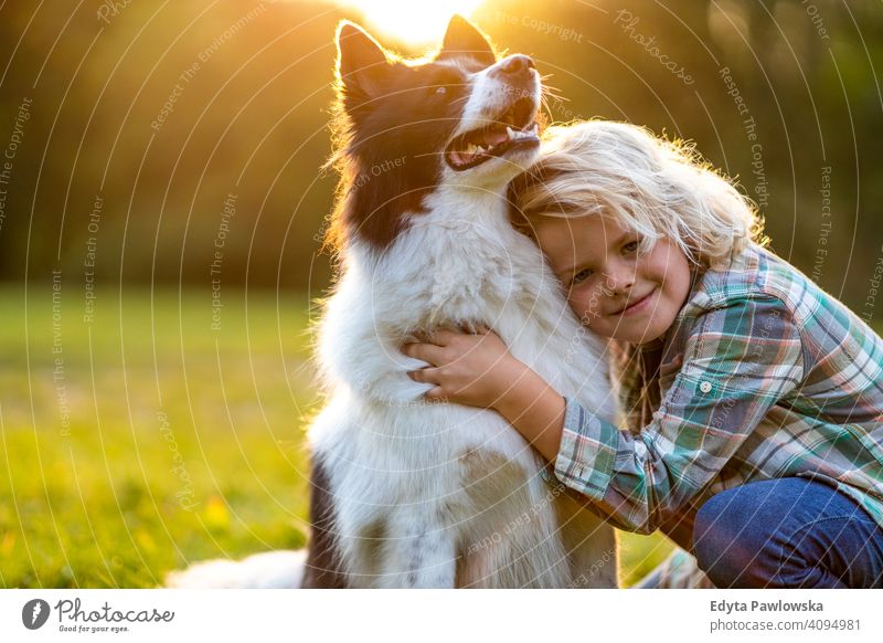 Little boy playing with his dog outdoors in the park people child little boy kids childhood casual cute beautiful portrait lifestyle elementary leisure