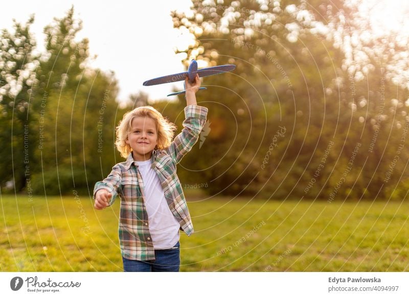 Little boy playing with toy plane in park people child little boy kids childhood outdoors casual cute beautiful portrait lifestyle elementary leisure preschool