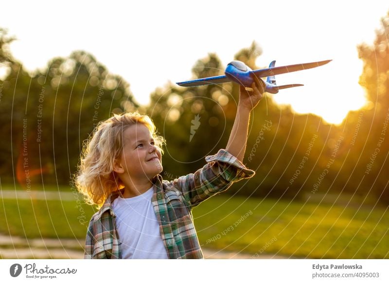 Little boy playing with toy plane in park people child little boy kids childhood outdoors casual cute beautiful portrait lifestyle elementary leisure preschool