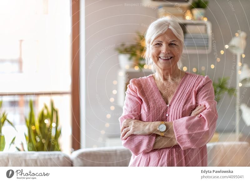 Confident senior woman in her home happy smiling enjoying positive confident content people one person mature pensioners retiree retired retirement old elderly