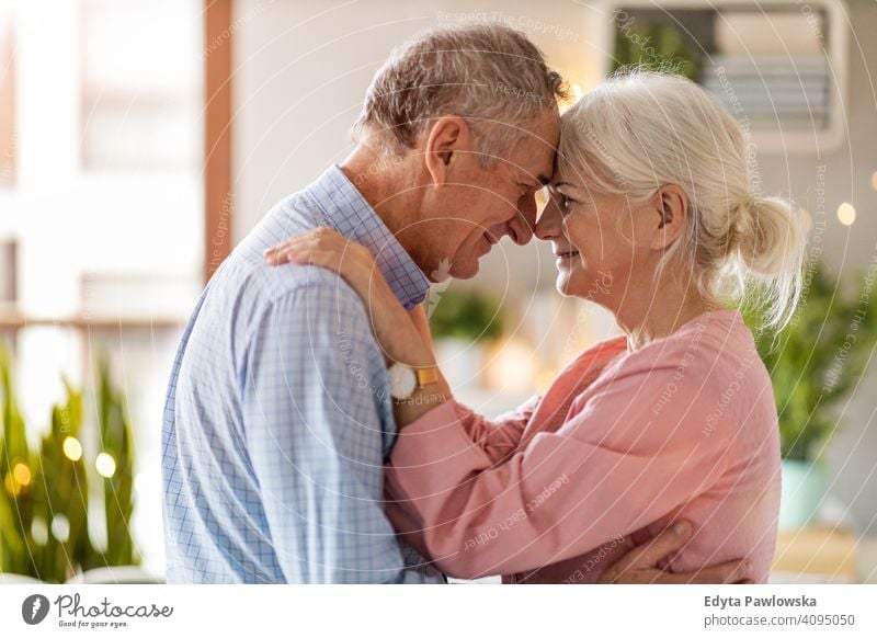 Happy senior couple at home people woman adult mature casual attractive female smiling happy Caucasian toothy enjoying two people love relationship portrait