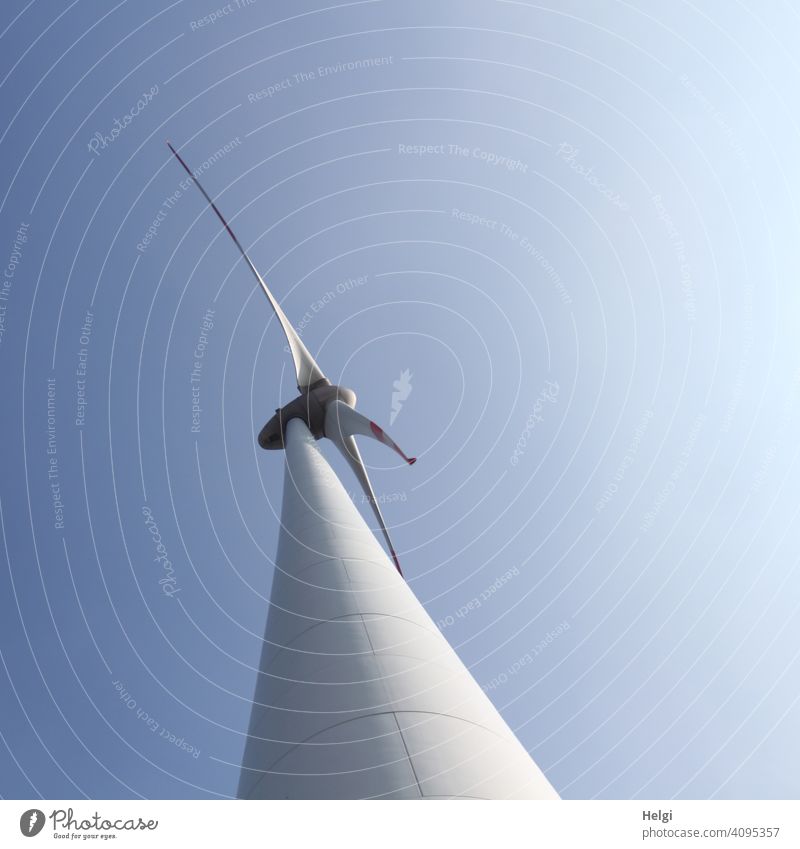 huge wind turbine from frog perspective in front of blue sky Pinwheel Wind energy plant Energy Energy generation Renewable energy Environmental protection