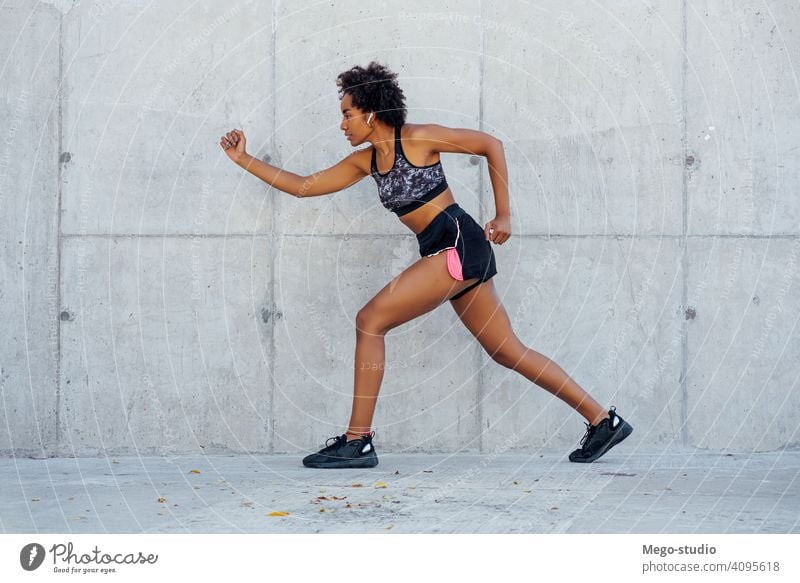 Afro athletic woman running outdoors. sport exercise training runner background people care leisure body portrait sports action motion cardio exercising
