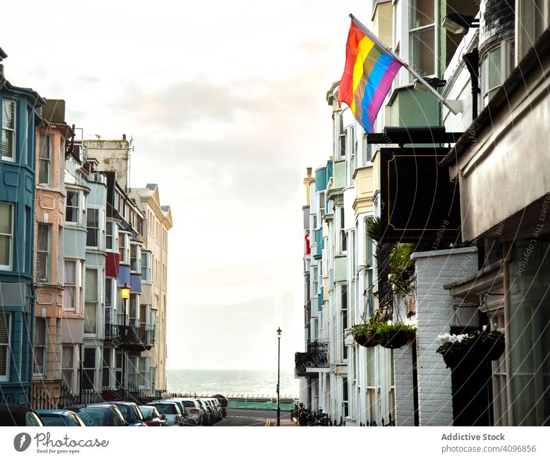 LGBT flag on town street lgbt residential building sea brighton england rainbow symbol exterior facade sky cloudy city pride sign colorful equality diversity