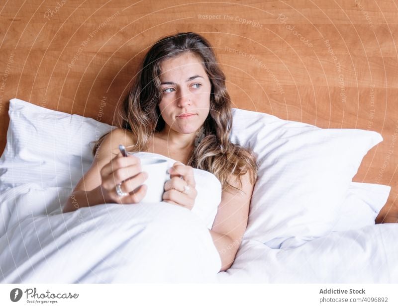 Girl in a bed with a cup of coffee pretty awake joy girl beauty indoors view home lying down sleep rest lifestyle beautiful waking young awakening morning