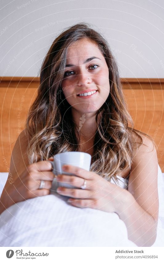 Girl in a bed with a cup of coffee pretty awake joy girl beauty indoors view home lying down sleep rest lifestyle beautiful waking young awakening morning