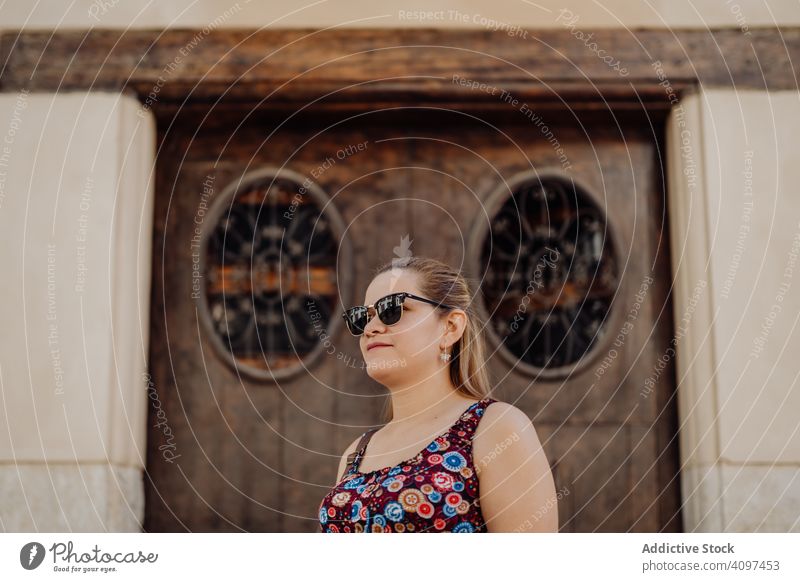Woman in sunglasses on background of ornamental door woman town travel style dream freedom inspiration street carefree architecture decoration sightseeing city