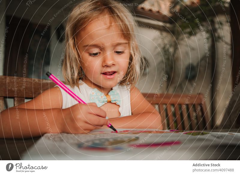 Girl coloring pictures at home girl book marker pen table lean draw kid education child creative art focused concentrated busy occupation lifestyle rest relax