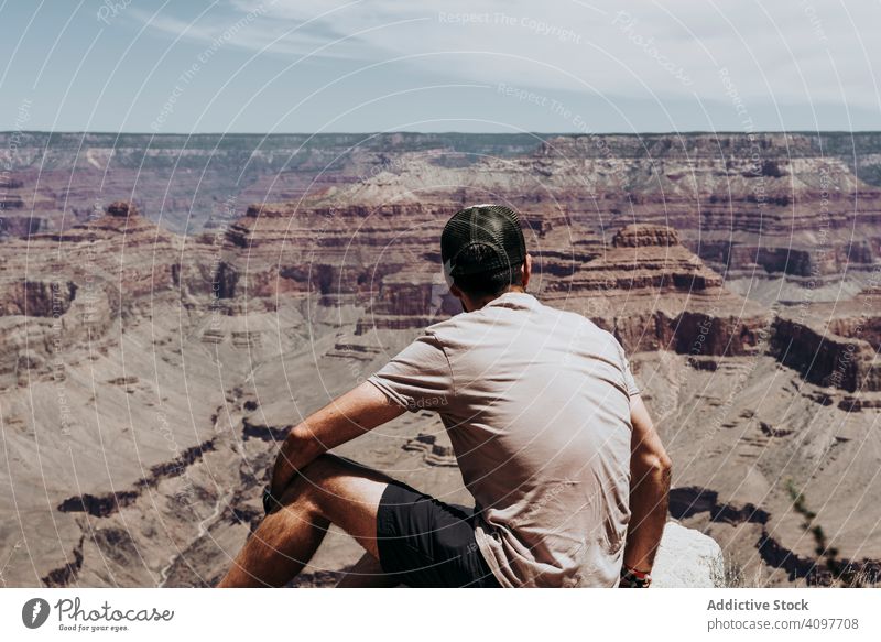 Tourist gazing while standing on edge of picturesque canyon tourist gaze cliff mountain range man contemplating summer usa hot scenic greenery blue sky mist