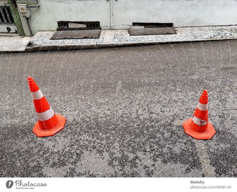 Lücbeck hats in large and small on grey asphalt in front of a hotel in the alleys of the old town of Bursa in Turkey Traffic cone Lübeck cone Street Alley
