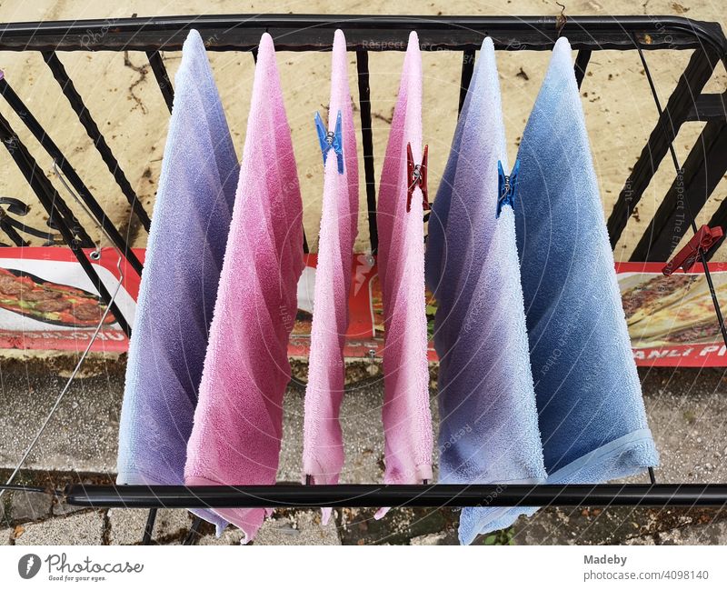 Towels in pink and light blue on the clothes horse on a balcony in the old town of Bursa in Turkey Terry cloth Dry Drying Laundry Cotheshorse clothesline Pink