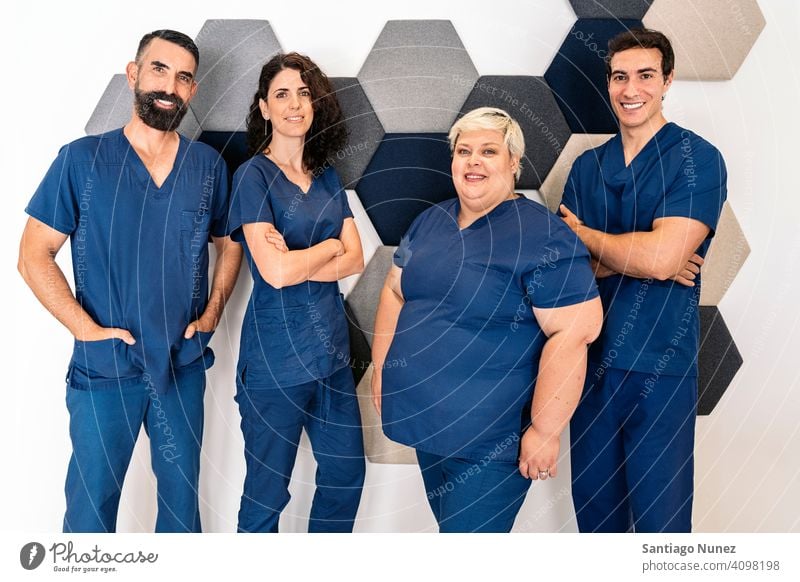 Dental Clinic Work Team team work team dental clinic professionals mixed men women together looking at camera at work workplace bearded man male work uniform