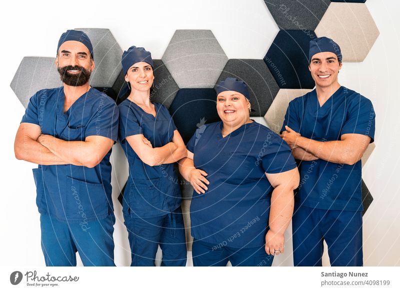 Happy Dental Clinic Work Team team work team dental clinic professionals mixed men women together looking at camera at work workplace bearded man male