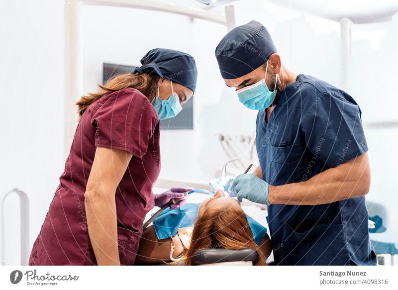 Dental Clinic Workers back view man woman patient standing looking examining dentist clinic dental clinic lying health care equipment medicine medical treatment