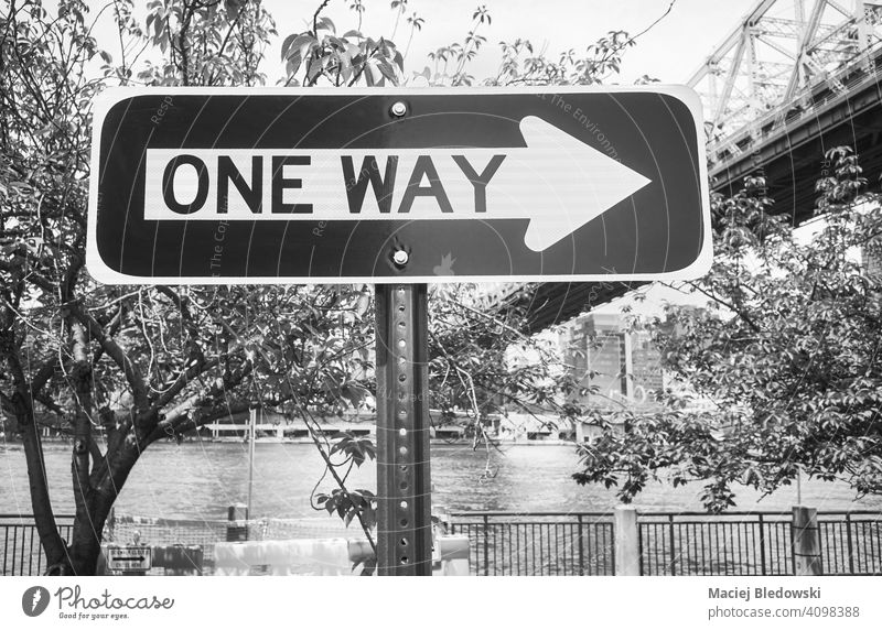 Black and white picture of One Way street sign in Roosevelt Island, New York City, USA. one way arrow city black and white NYC cityscape B&W travel transport