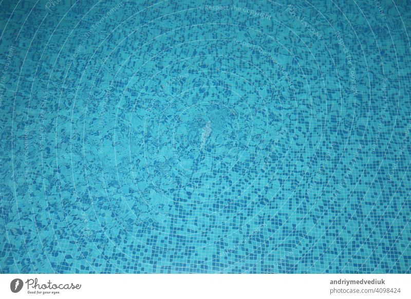 blue water in the pool. selective focus. mosaic background pattern floor surface texture color clean abstract underwater light textured wave square swimming