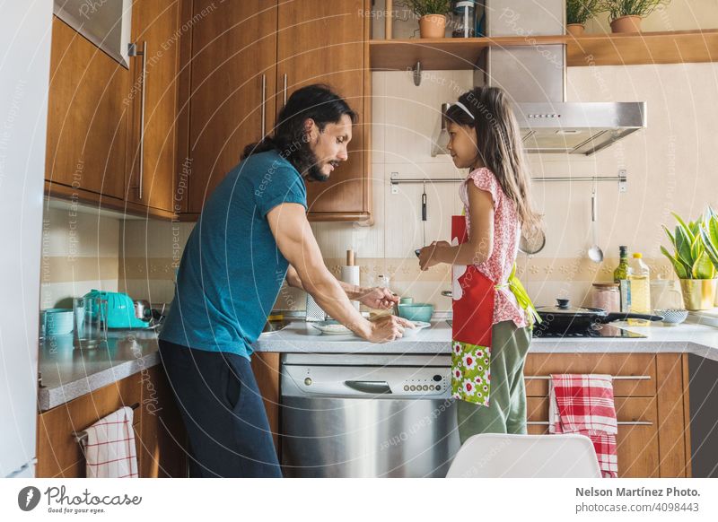 Happy family cooking in the kitchen. Father and child daughter cooking home people vitamin food copy space dairy young snack pleasure pretty father health