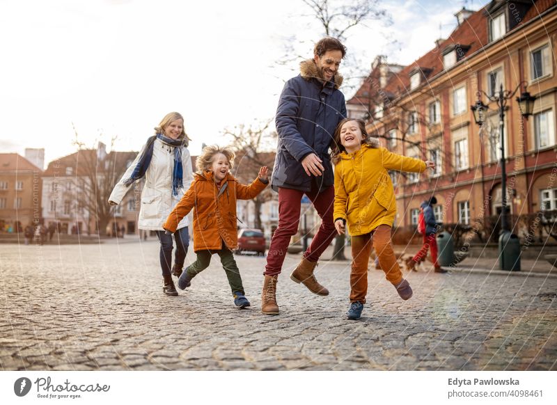 Affectionate young family enjoying their day in a city winter man autumn father woman mother parents relatives son boys kids children relationship together