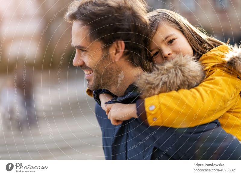 Dad and son hugging outdoors young carrying piggyback embracing winter man autumn father family parents relatives boy kids children relationship together