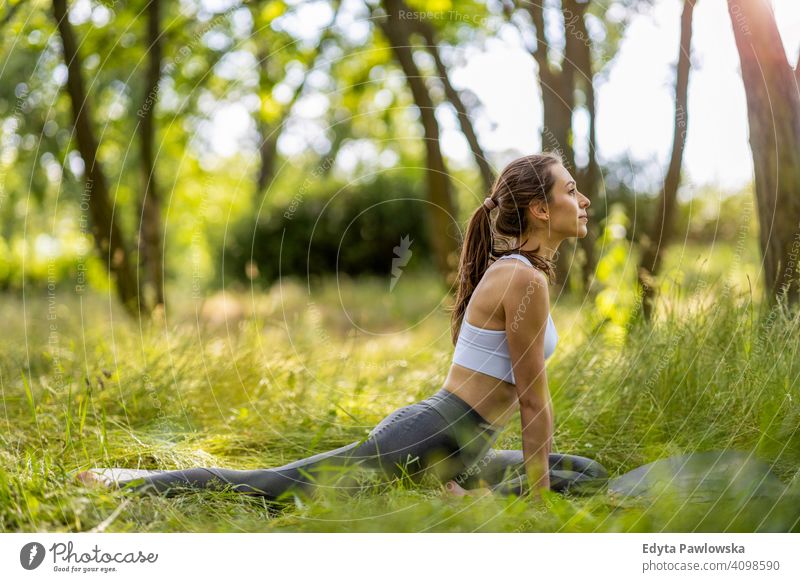 Fit young woman exercising in nature natural girl people female recreation healthy wellbeing lifestyle active vitality outdoors adult outside attractive