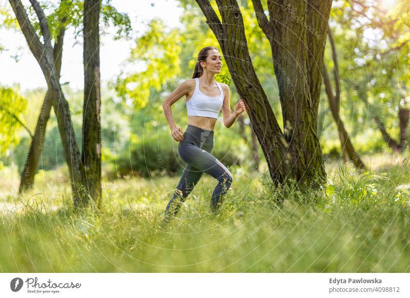 Fit young woman exercising in nature natural girl people female recreation healthy wellbeing lifestyle active vitality outdoors adult outside attractive