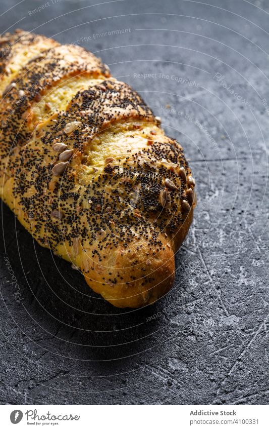 Loaf of bread with grains and poppy seeds loaf fresh food bakery wheat healthy homemade cuisine nutrition rustic recipe long baguette product ruddy crispy crust