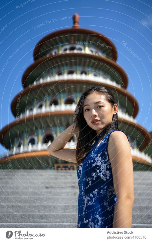 Woman in dress standing next to Wuji Tianyuan Temple East Asia Taiwan Taoist temple taipei woman oriental stairs traditional religion ancient culture female