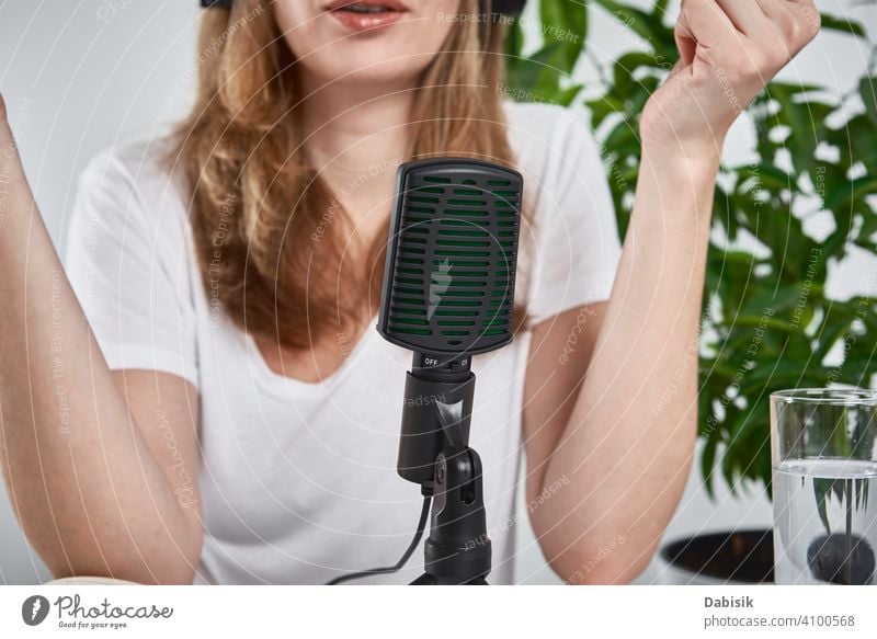 Woman recording online podcast at home. Microphone on table. home studio workplace microphone radio blogger broadcasting media professional audio technology