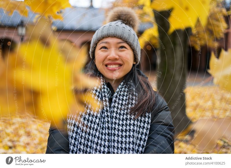 Happy ethnic female tourist enjoying autumn in Oslo woman throw maple leaf patio travel nature holiday relax rest vacation tourism oslo cathedral norway
