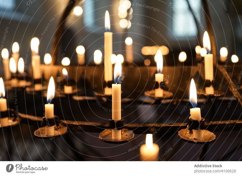 Candles burning in Oslo Cathedral in Norway candle candlestick flame glow darkness traditional interior religion fire light paraffin oslo cathedral norway