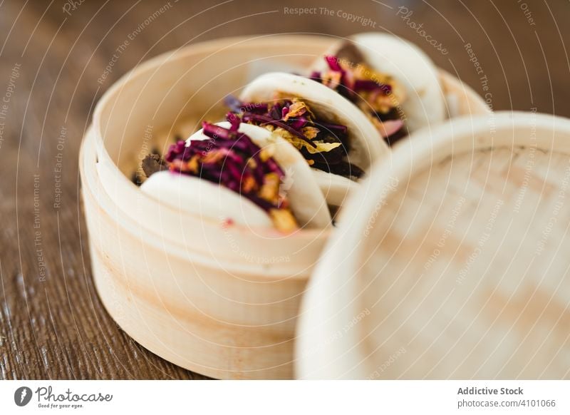 Traditional Asian steamed buns in bamboo steamer asian traditional bread food snack sandwich bao gua bao cuisine chinese taiwanese meal meat stuffed vegetables