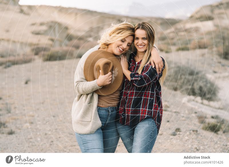 Content blond women cuddling on nature cuddle tender love support embrace hug content smile blond hair together female relationship lifestyle care innocent
