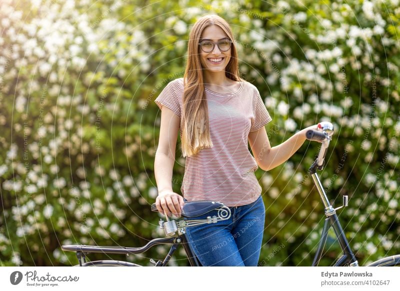 Young woman going for a bicycle ride in the park active Bicycle Bike On The Move commuter transport cycling biking healthy eco-friendly ecological enjoying
