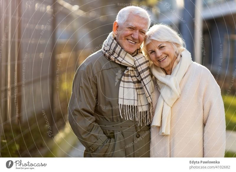 Senior couple hugging outdoors in autumn woman love people together two senior mature pensioners togetherness retiree retired retirement old marriage healthy