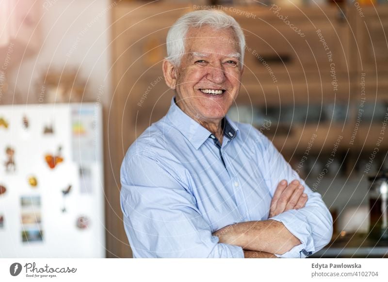 Smiling senior man in his home people one person mature pensioners retiree retired retirement old elderly gray hair caucasian adult lifestyle happy smiling
