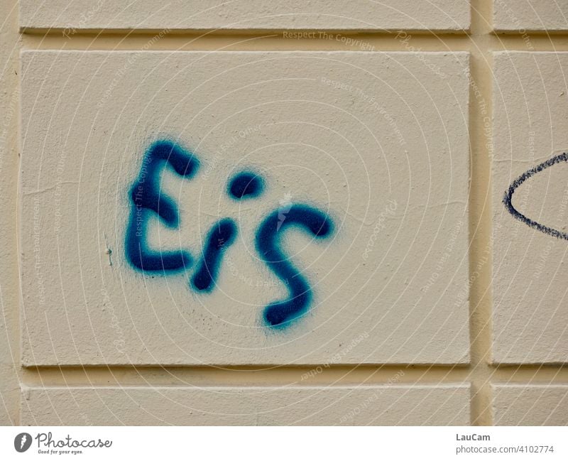 Blue lettering "Eis" on light-coloured house facade Ice writing Letters (alphabet) Word Facade Yellow Wall (building) Graffiti Colour photo Street art Daub
