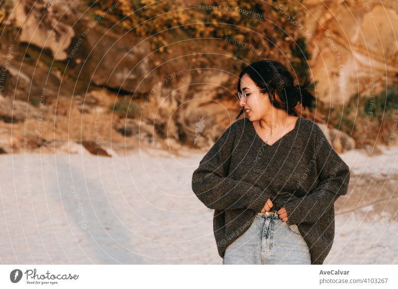 Young woman on spring clothes at the beach during a sunset with copy space carefree happiness person enjoyment freedom horizontal silhouette sunrise vitality