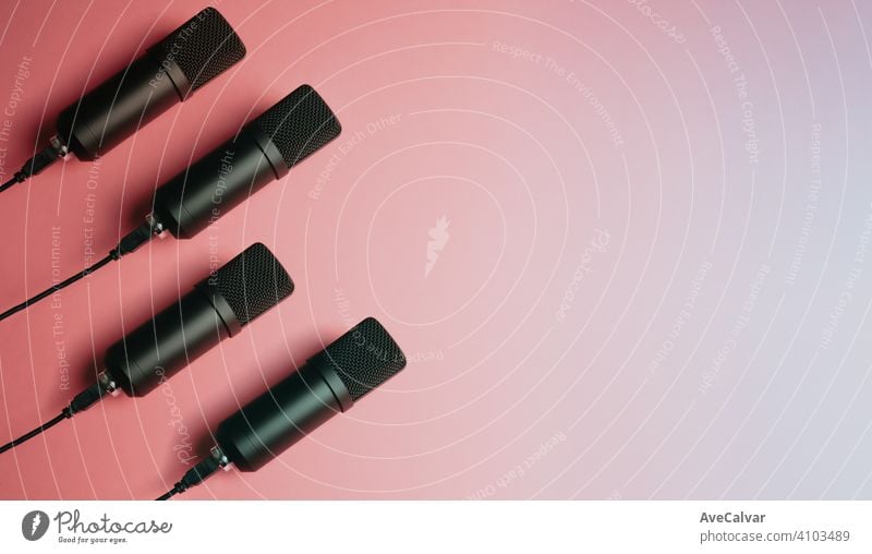 Mock up design of floating streaming mics microphones over a pink pastel background with copy space record audio technology music professional sound radio