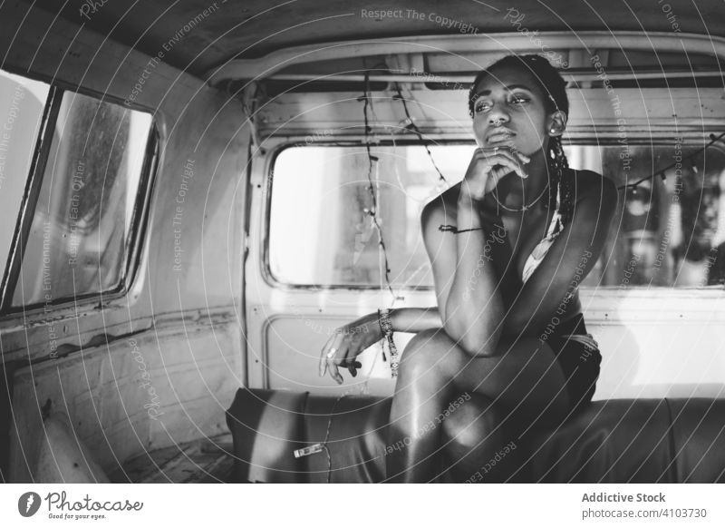 Pensive African American woman sitting in vintage van pensive dream thoughtful think relax retro bus african american black summer female beautiful young pretty