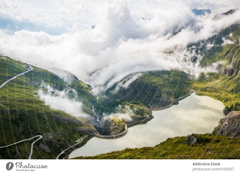 Clouds over mountains and calm lake cloud terrain water weather alpine landscape austria nature nobody green scenic picturesque breathtaking pond basin overcast
