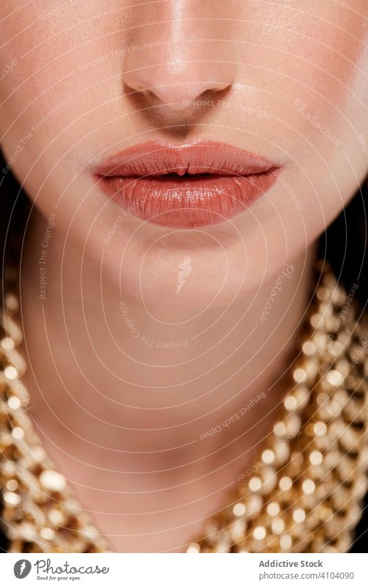 Beautiful lips of fashionable woman makeup accessories lipstick golden chain stylish beautiful model female color professional luxury mouth skin young sensual
