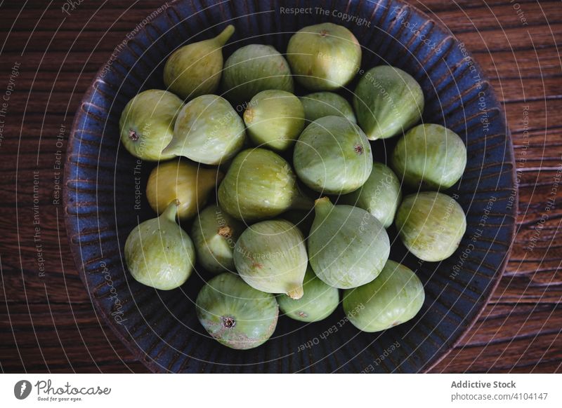 Bowl with figs on table fruit bowl gourmet snack meal ripe food agriculture healthy plant diet rustic crunchy nutritious timber wood natural seasonal delicious
