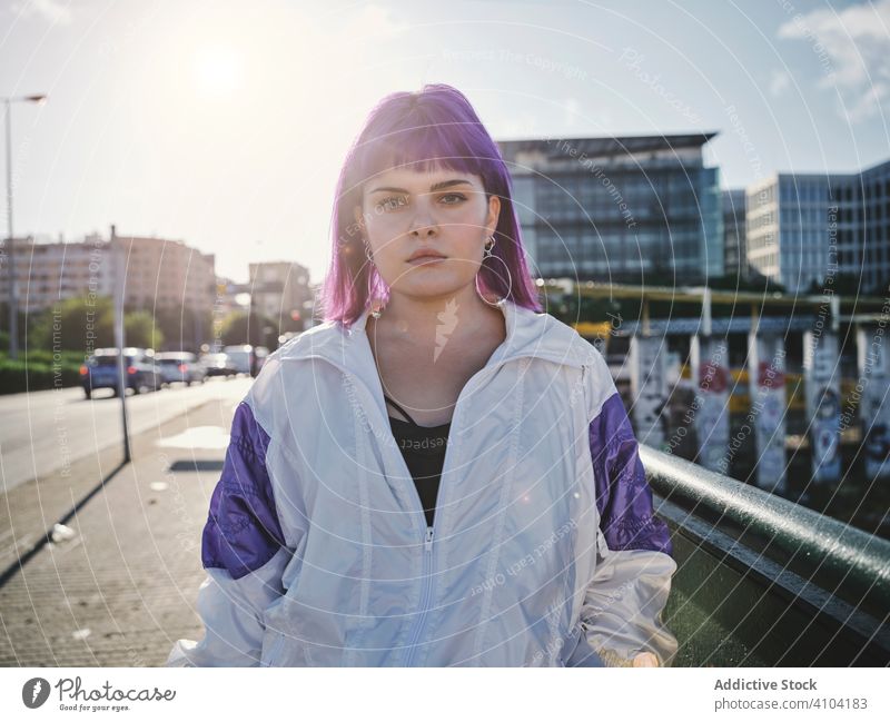 Woman with purple hair leaning on metal fence woman stylish urban hairstyle jacket district confident fashion young model street human female exterior outfit