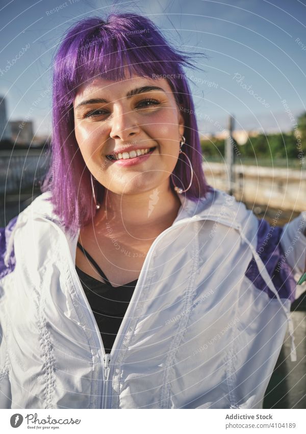 Woman with purple hair leaning on metal fence woman stylish urban hairstyle jacket district confident fashion young model street human female exterior outfit
